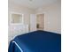 Cozy bedroom featuring a blue bed, dresser, and neutral walls at 7517 Laureate Blvd # 4303, Orlando, FL 32827