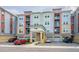 Well-maintained building exterior with ample parking and a neatly landscaped entrance at 7517 Laureate Blvd # 4303, Orlando, FL 32827