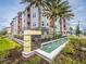 Welcoming community entrance with lush landscaping and a water feature by the Gatherings sign at 7517 Laureate Blvd # 4303, Orlando, FL 32827