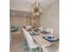 Open-concept dining room with a large wooden table, comfortable seating, and modern lighting at 7517 Laureate Blvd # 4303, Orlando, FL 32827