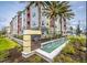 Beautiful condo building with palm trees and water feature at Gatherings of Lake Nona at 7517 Laureate Blvd # 4303, Orlando, FL 32827
