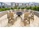 Outdoor fire pit area with Adirondack chairs surrounded by landscaping with apartments in background at 7517 Laureate Blvd # 4303, Orlando, FL 32827