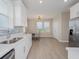 Bright breakfast nook with white cabinets, stainless steel appliances, and a view of the lush outdoors at 7517 Laureate Blvd # 4303, Orlando, FL 32827