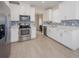 Bright kitchen with stainless steel appliances, white cabinets, blue backsplash, and lots of natural light at 7517 Laureate Blvd # 4303, Orlando, FL 32827