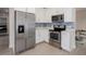 Well-equipped kitchen with stainless steel appliances, white cabinets, and a stylish blue backsplash at 7517 Laureate Blvd # 4303, Orlando, FL 32827