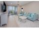 Inviting living room with a balcony, a blue sofa, and modern neutral decor at 7517 Laureate Blvd # 4303, Orlando, FL 32827