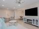 Open concept living room featuring tile floors, modern lighting, and a decorative fireplace and TV at 7517 Laureate Blvd # 4303, Orlando, FL 32827