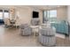 Airy living room with comfortable seating, modern decor, and sliding glass doors leading to a balcony at 7517 Laureate Blvd # 4303, Orlando, FL 32827