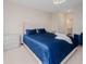 Spacious main bedroom with an elegant blue bed and neutral decor at 7517 Laureate Blvd # 4303, Orlando, FL 32827