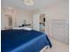 Bright main bedroom showcasing a blue bed, ample closet space and access to the bathroom at 7517 Laureate Blvd # 4303, Orlando, FL 32827