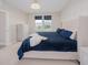 Main bedroom with a plush blue bed, light walls, and stylish furnishings at 7517 Laureate Blvd # 4303, Orlando, FL 32827