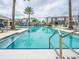 Sparkling pool area with palm trees and lounge chairs, perfect for relaxation and recreation at 7517 Laureate Blvd # 4303, Orlando, FL 32827