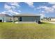 Backyard featuring a well-maintained lawn and side patio at 1047 Aruba Ave, Mulberry, FL 33860