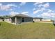 Backyard featuring a covered patio and well-maintained lawn at 1047 Aruba Ave, Mulberry, FL 33860