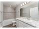 Bathroom with decorative tile, shower and tub combo and single sink vanity at 1047 Aruba Ave, Mulberry, FL 33860