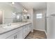 Bathroom with double sink vanity, large mirror, and walk-in shower at 1047 Aruba Ave, Mulberry, FL 33860