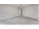 Spacious bedroom with neutral gray carpet and ceiling fan with lighting at 1047 Aruba Ave, Mulberry, FL 33860