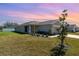 Charming single-story home featuring a well-manicured lawn and neutral paint scheme at 1047 Aruba Ave, Mulberry, FL 33860