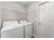 Laundry room featuring a side-by-side washer and dryer and wire shelving at 1047 Aruba Ave, Mulberry, FL 33860