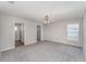 Spacious primary bedroom with neutral carpet, ceiling fan, and ensuite bathroom at 1047 Aruba Ave, Mulberry, FL 33860