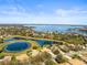 Breathtaking aerial view showcasing expansive lakefront property surrounded by lush landscaping and luxurious homes at 11321 Ledgement Ln, Windermere, FL 34786