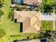 Overhead shot of the tile roof and backyard featuring tropical landscaping, the pool, and other homes in the neighborhood at 11321 Ledgement Ln, Windermere, FL 34786