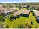 Aerial view of a home featuring a spacious backyard, screened lanai, pool, and well-maintained landscaping at 11321 Ledgement Ln, Windermere, FL 34786