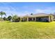 Expansive backyard featuring lush green grass and the home's exterior at 11321 Ledgement Ln, Windermere, FL 34786