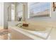 Luxurious soaking tub with tiled surround and a separate shower at 11321 Ledgement Ln, Windermere, FL 34786