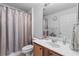 Bathroom featuring a vanity, mirror, toilet, and a shower with a silver curtain at 11321 Ledgement Ln, Windermere, FL 34786
