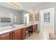 Bright and airy primary bathroom featuring a double vanity, soaking tub, and natural light at 11321 Ledgement Ln, Windermere, FL 34786