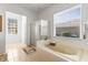 Bright bathroom featuring a large window, a walk-in shower and a soaking tub at 11321 Ledgement Ln, Windermere, FL 34786