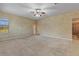Large bedroom with neutral walls, carpet, ceiling fan, and window offering natural light and backyard views at 11321 Ledgement Ln, Windermere, FL 34786