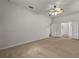 Spacious bedroom features neutral carpet, a ceiling fan, and ensuite bathroom at 11321 Ledgement Ln, Windermere, FL 34786