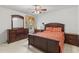 Bedroom with dark wood furniture, including dresser, nightstand, and bed frame, providing a cozy and traditional aesthetic at 11321 Ledgement Ln, Windermere, FL 34786