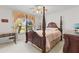 Bedroom with a four-poster bed, desk, and a window offering a view at 11321 Ledgement Ln, Windermere, FL 34786