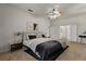 Stylishly furnished bedroom with neutral carpet, a ceiling fan, and ensuite bathroom at 11321 Ledgement Ln, Windermere, FL 34786