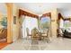 Sunlit breakfast nook features a round glass table, stylish chairs, and views to the backyard at 11321 Ledgement Ln, Windermere, FL 34786