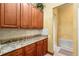 Butler pantry features custom cabinetry, granite countertops, and backsplash at 11321 Ledgement Ln, Windermere, FL 34786