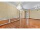 Spacious dining room featuring hardwood floors, elegant chandelier, and decorative molding at 11321 Ledgement Ln, Windermere, FL 34786