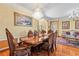 A formal dining room with hardwood floors, chandelier and ornate table setting at 11321 Ledgement Ln, Windermere, FL 34786