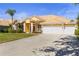 Charming yellow single-story home boasts a tile roof, well-manicured lawn, and a spacious three-car garage at 11321 Ledgement Ln, Windermere, FL 34786