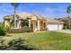 Charming single-story home with tile roof, well-manicured lawn and lush landscaping with a convenient two car garage at 11321 Ledgement Ln, Windermere, FL 34786