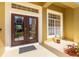 Elegant double front doors framed by decorative pillars and manicured landscaping at the entrance at 11321 Ledgement Ln, Windermere, FL 34786