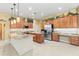 Bright kitchen featuring stainless steel appliances, custom cabinets, and a large island with granite countertops at 11321 Ledgement Ln, Windermere, FL 34786