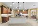 Bright kitchen featuring stainless steel appliances, custom wood cabinets and a large island with pendant lighting at 11321 Ledgement Ln, Windermere, FL 34786