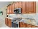 Custom kitchen design featuring granite countertops, stainless steel appliances, and custom wood cabinetry at 11321 Ledgement Ln, Windermere, FL 34786