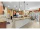 Spacious kitchen with custom wood cabinets, granite island, and adjacent dining area featuring a decorative chandelier at 11321 Ledgement Ln, Windermere, FL 34786