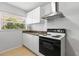 Functional kitchen featuring a range, vent hood, and efficient cabinet storage at 11321 Ledgement Ln, Windermere, FL 34786