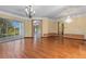 Spacious living area showcasing hardwood floors, chandelier, and ample natural light at 11321 Ledgement Ln, Windermere, FL 34786